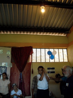 Honduran school boy turning on light