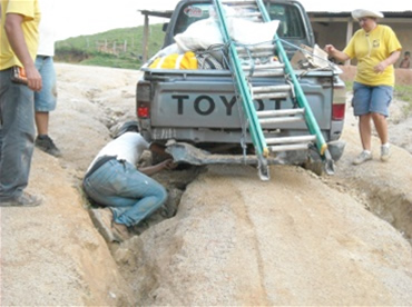 Man underneath truck, repairing truck