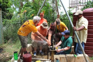 Sonlight Power team squirting water from newly installed well pump