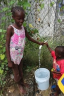 Children pumping water from the well