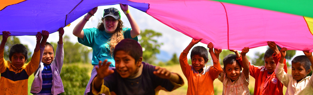 Honduras - Megan and kids under parachute in Yamaranguila