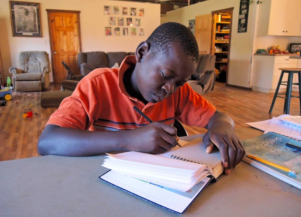 Boy Studying Under Light from Solar Power